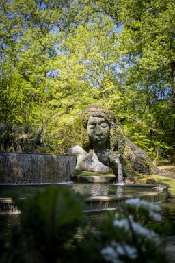 a water fountain with a statue of a woman in the middle of it
