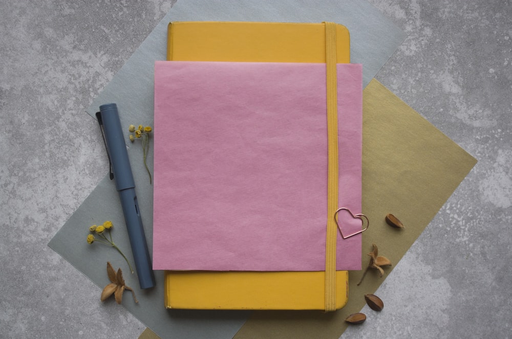 a pink and yellow notebook with a heart on it