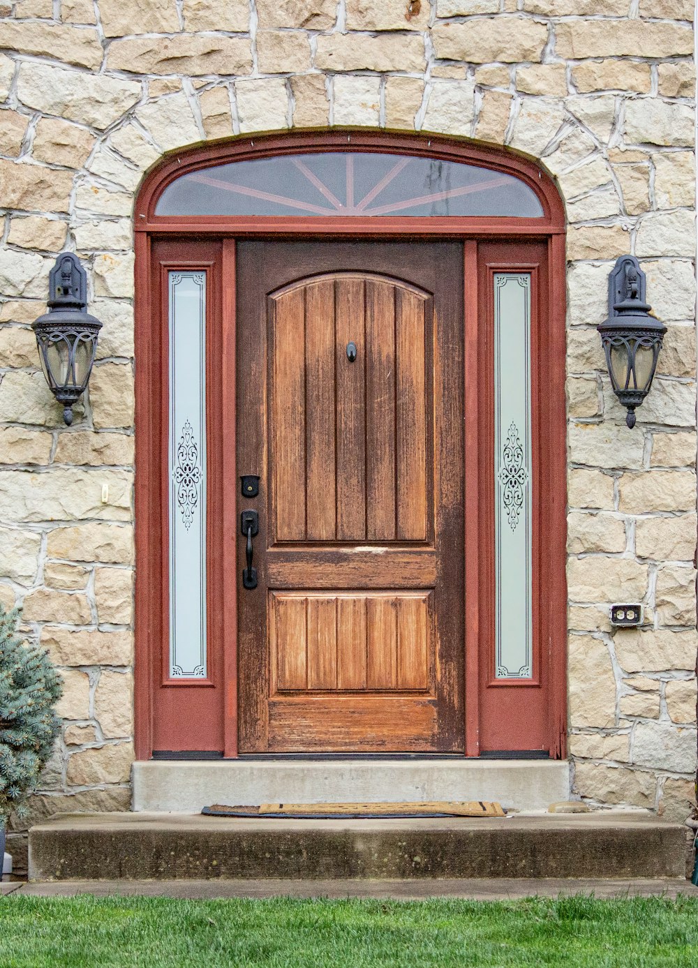 a wooden door sitting next to a stone building