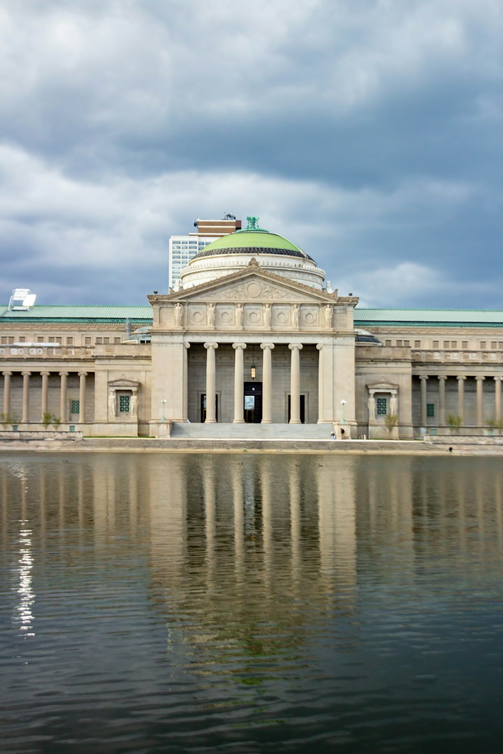 a large building sitting next to a body of water