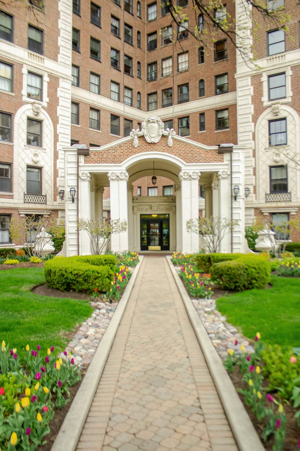 a brick building with a walkway leading to the front door