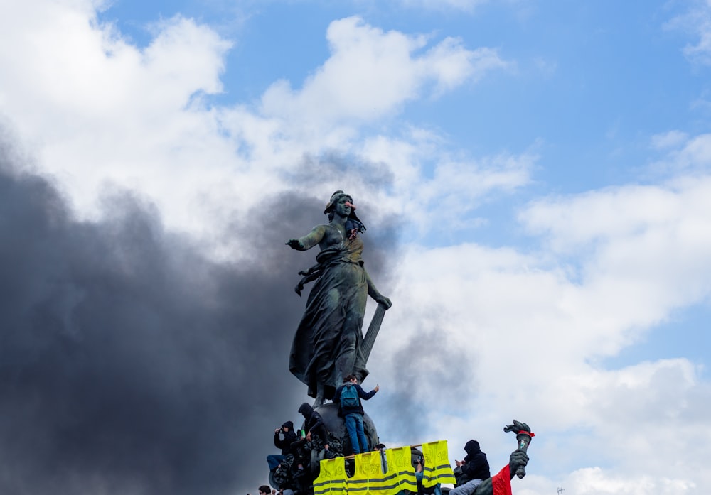 a group of people standing around a statue