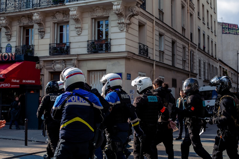 a group of police officers standing in front of a building