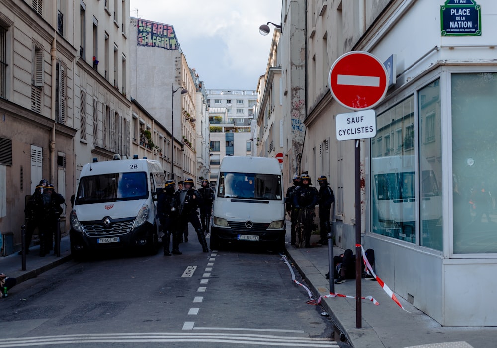 a group of police officers standing around a van