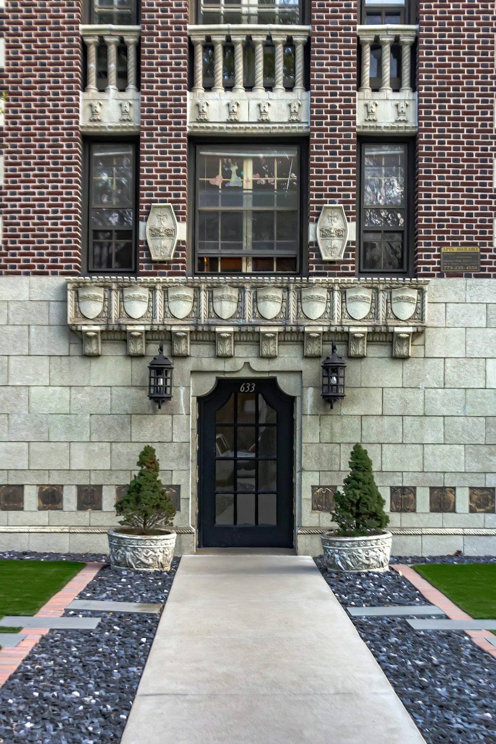 a large brick building with a black door and windows