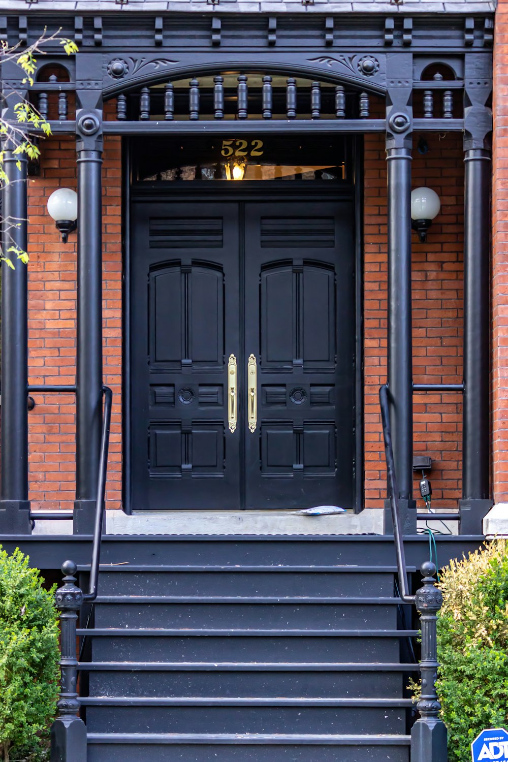 a black front door with two black steps leading up to it