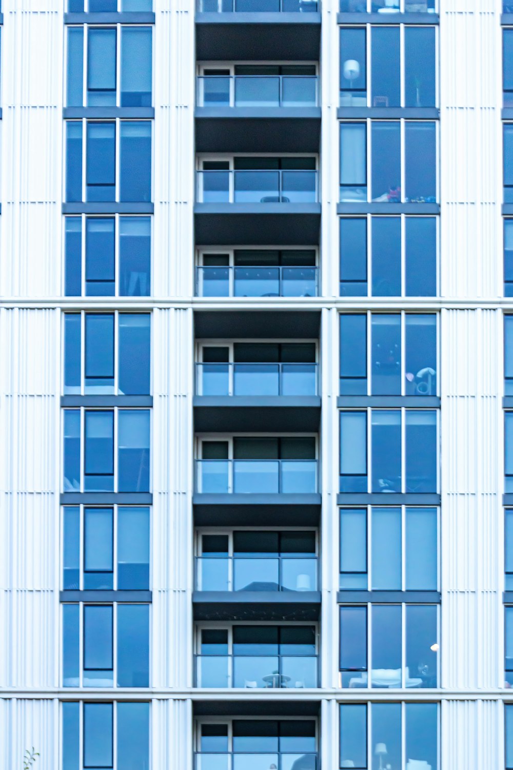 a tall white building with lots of windows