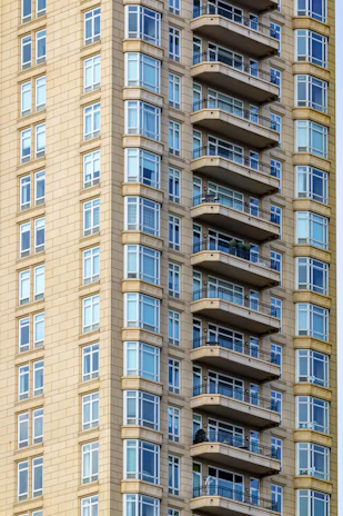 Exterior view of a newly launched modern residential building with large glass balconies.
