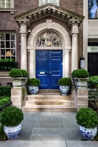 A warm, inviting home entrance with soft blue and gold accents reflecting Gryphon Senior Care's colors.