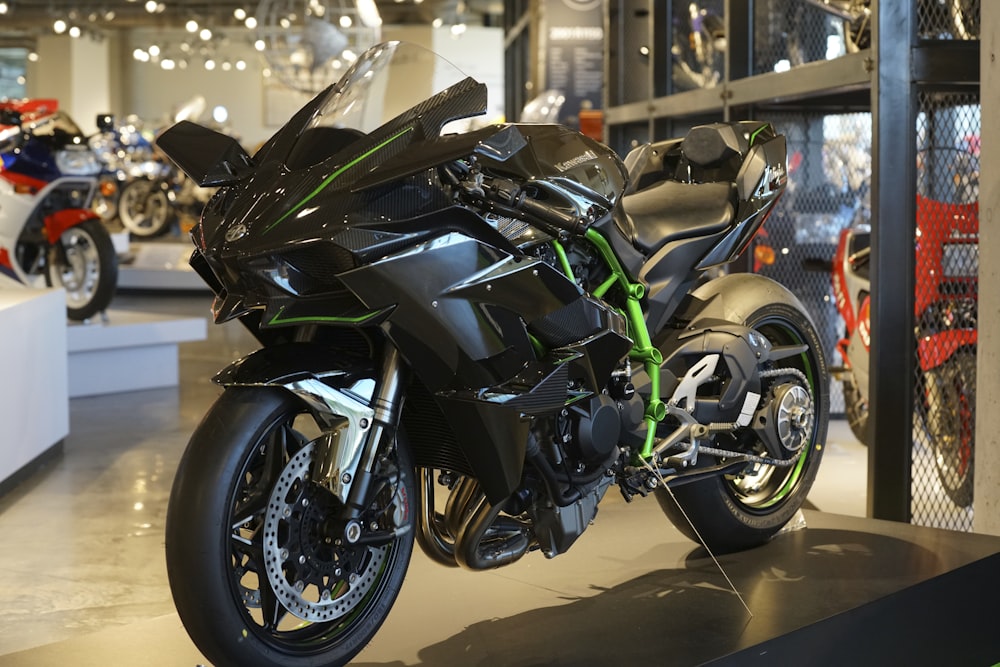 a black motorcycle is on display in a showroom