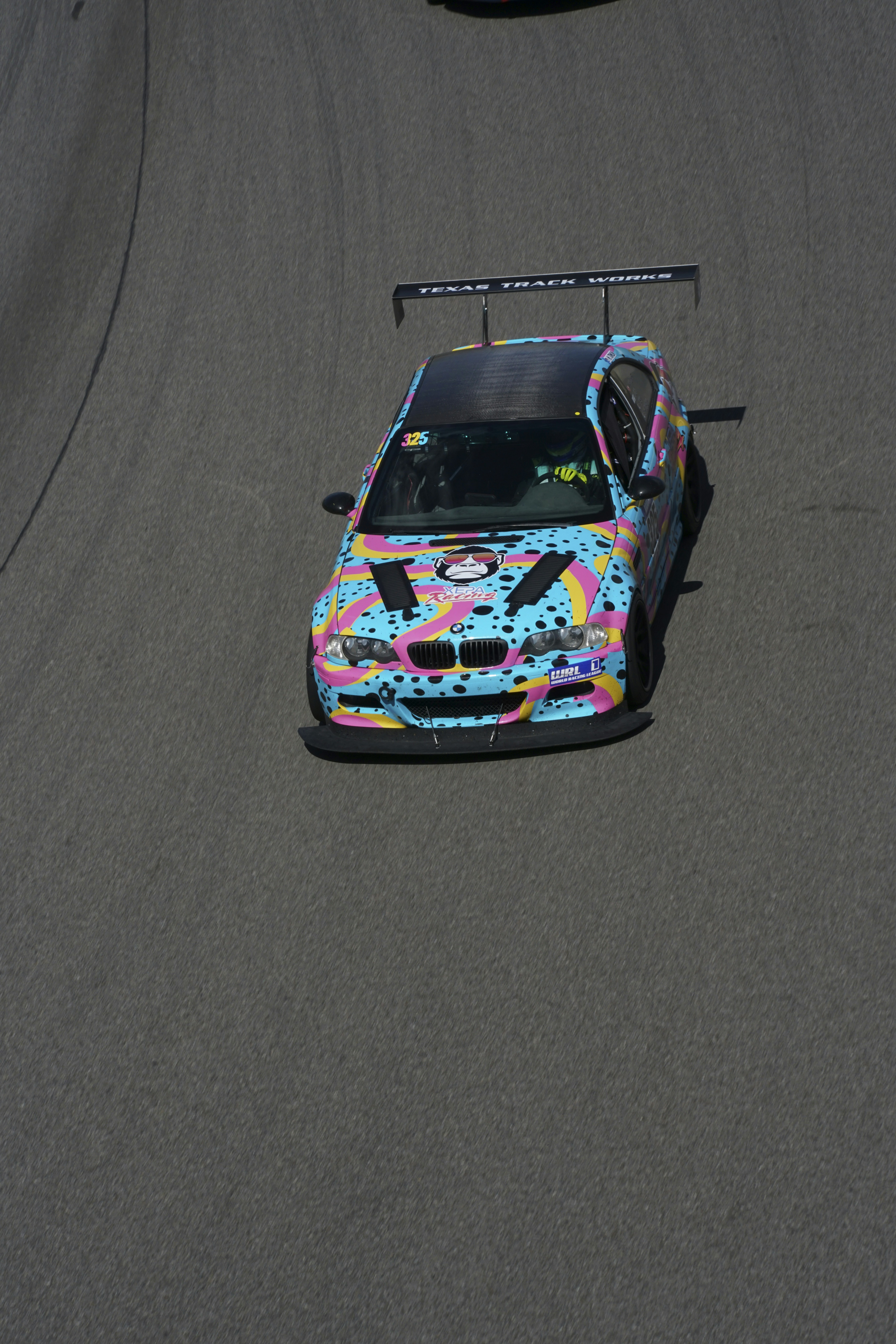 A colorful car driving on a race track photo – Free Bmw Image on Unsplash