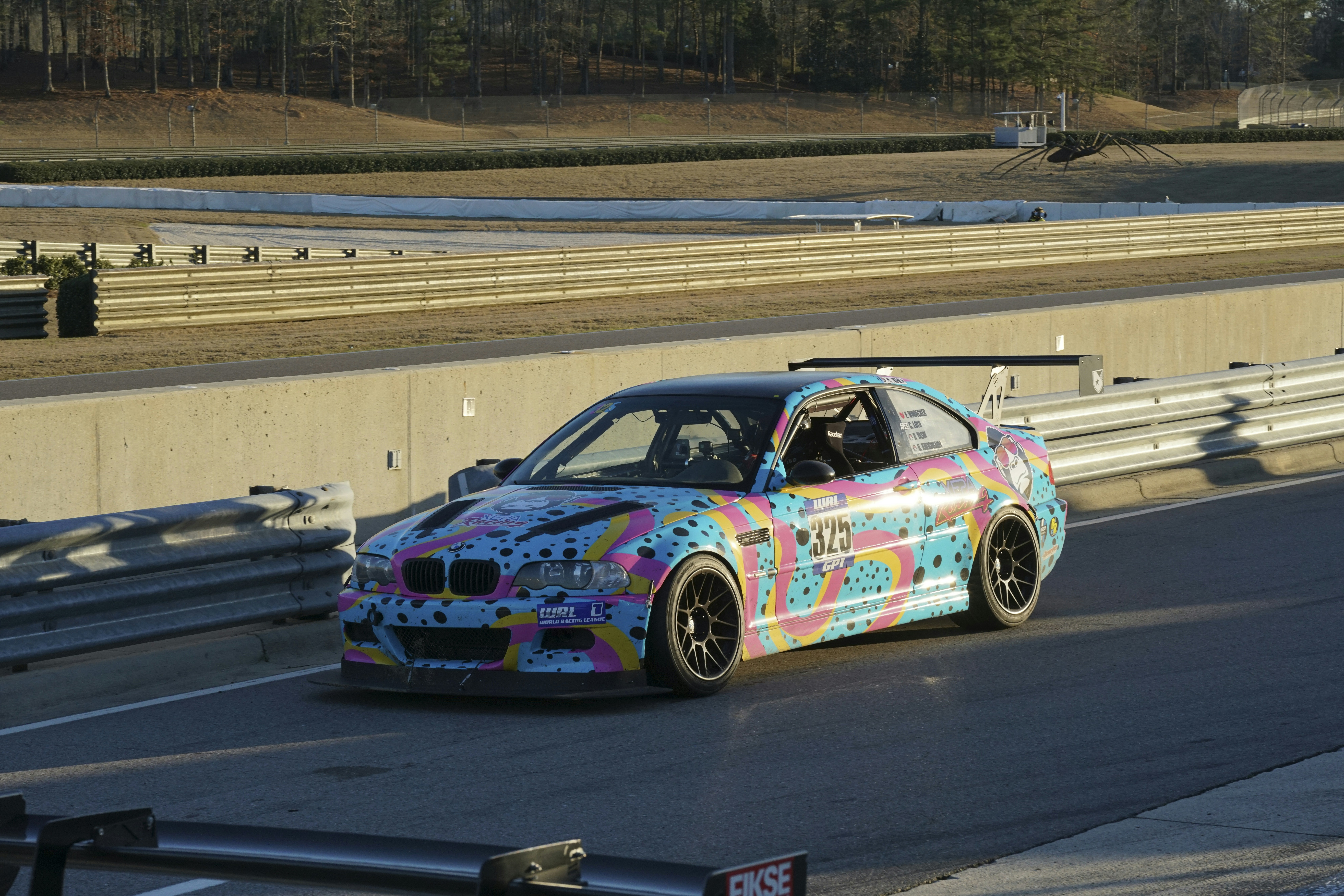 A colorful car driving on a race track photo – Free Bmw Image on Unsplash
