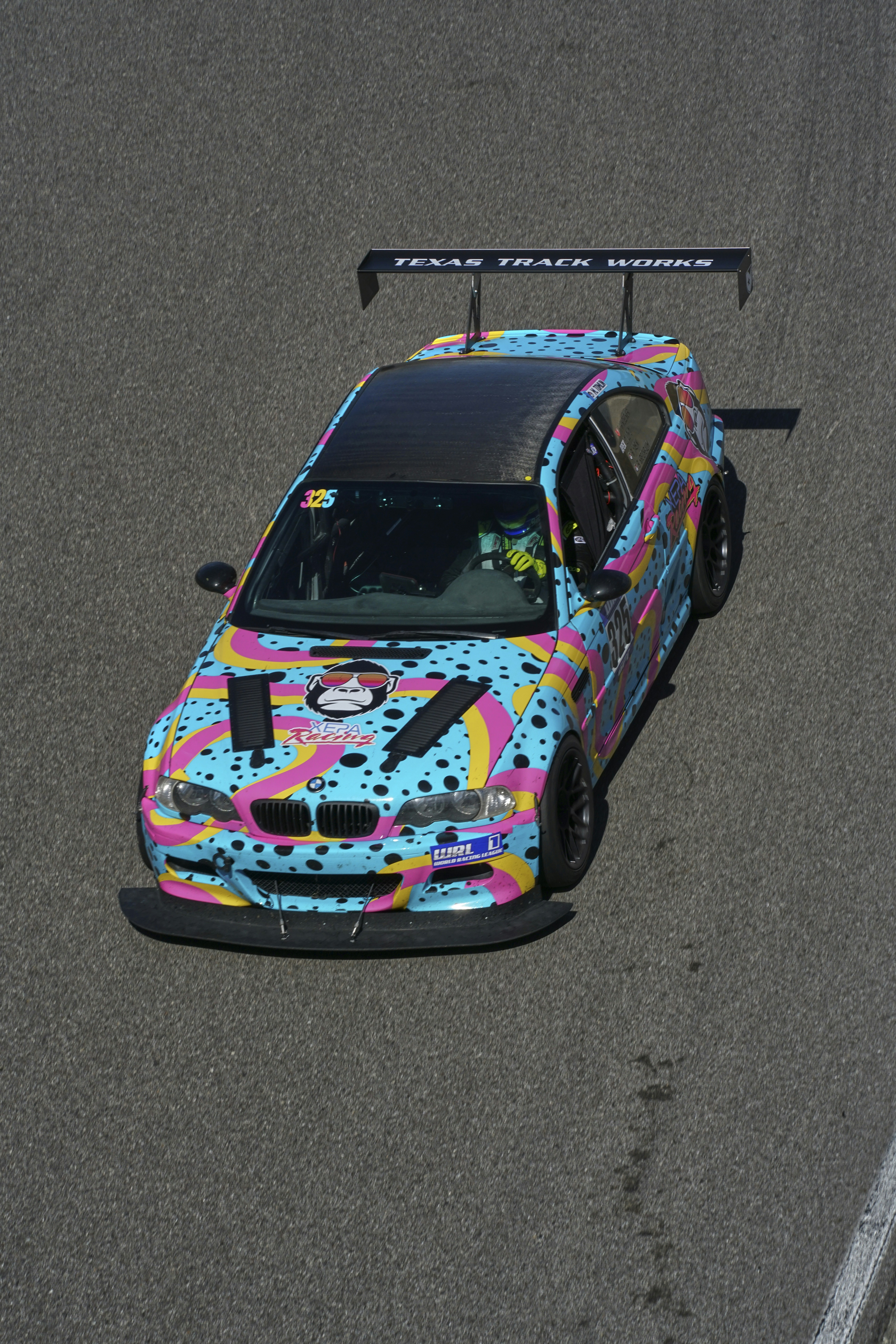 A colorful car driving on a race track photo – Free Bmw Image on Unsplash