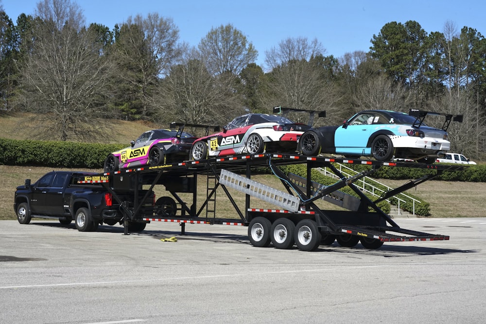 a flatbed trailer with cars on the back of it