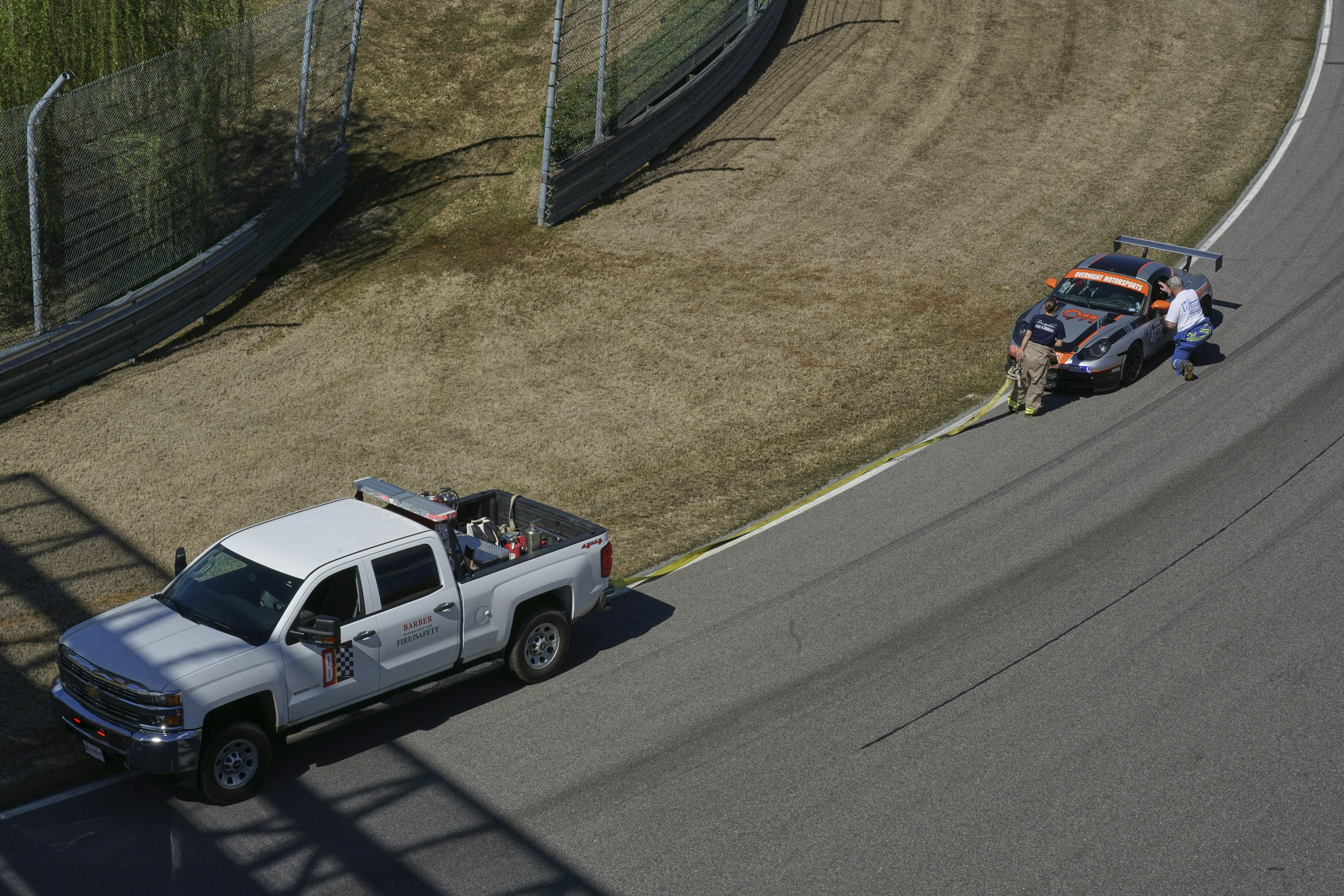 a white truck driving down a race track