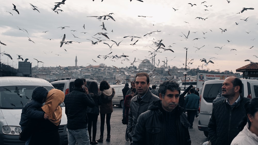 a group of people standing in a parking lot