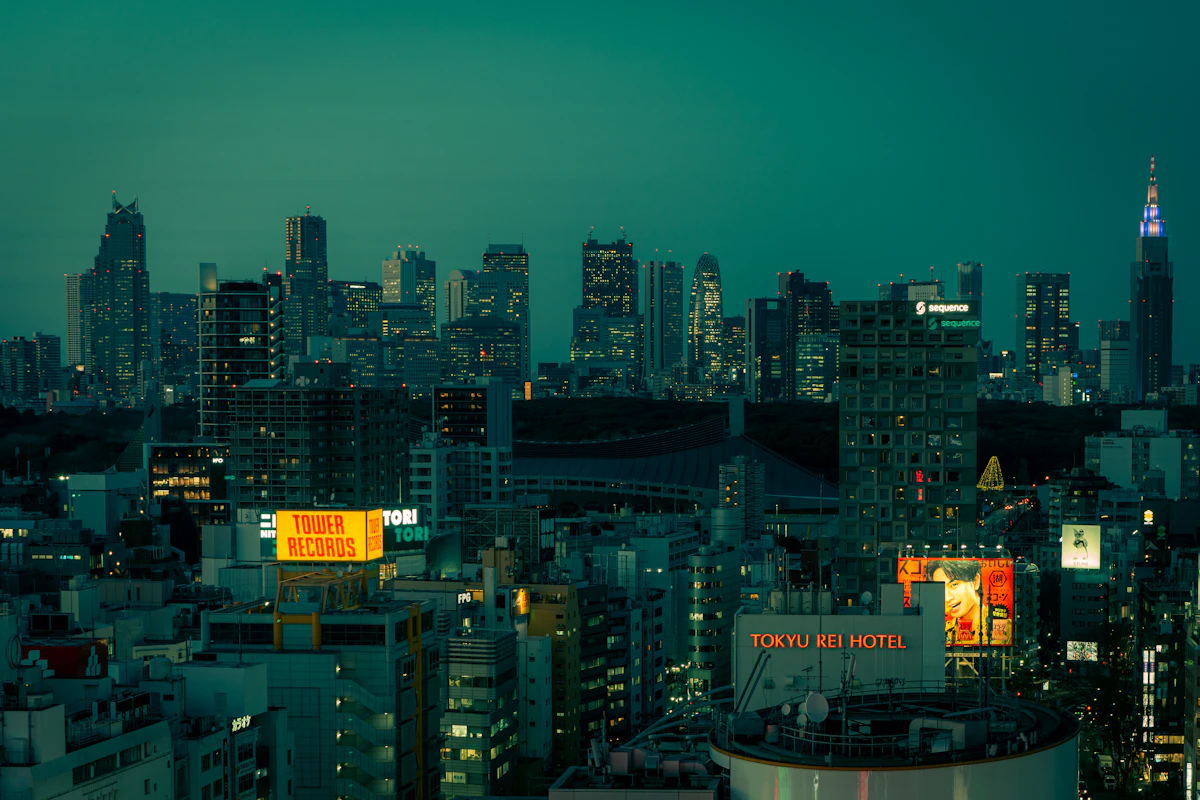 Tokyo skyline view at night from a Shinjuku skyscraper, with city lights stretching to the horizon