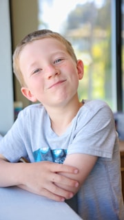 Smiling therapist engaging with a child in a bright, welcoming therapy room