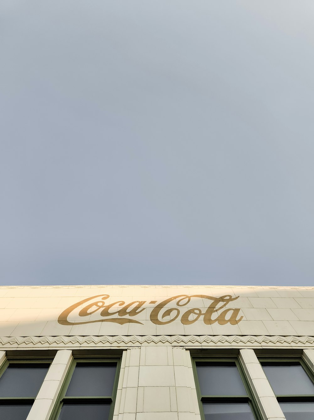 a coca cola sign on the side of a building