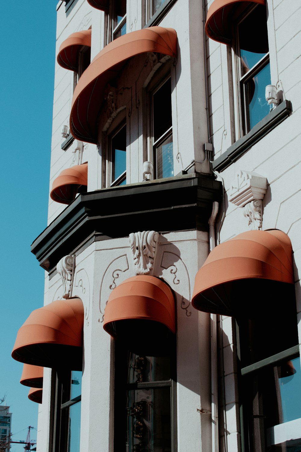 a tall building with orange awnings on the side of it