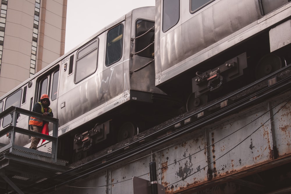 a man standing on a platform next to a train