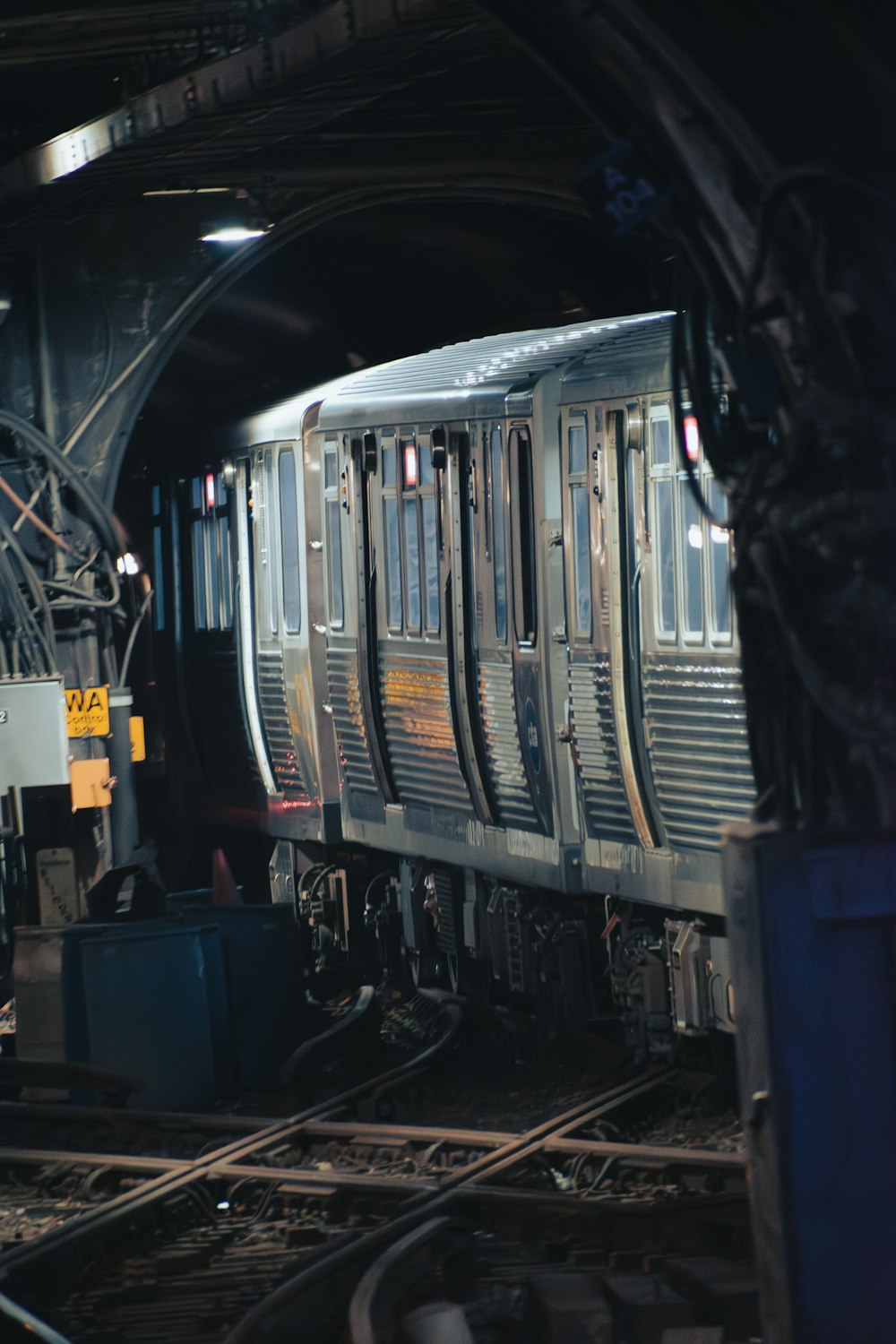 a train traveling through a train station under a bridge