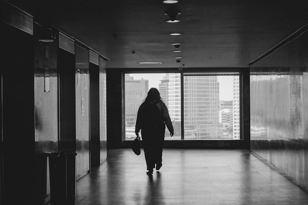 a person walking down a hallway in a building