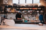 Kitchen counters crowded with dishes and groceries before service.