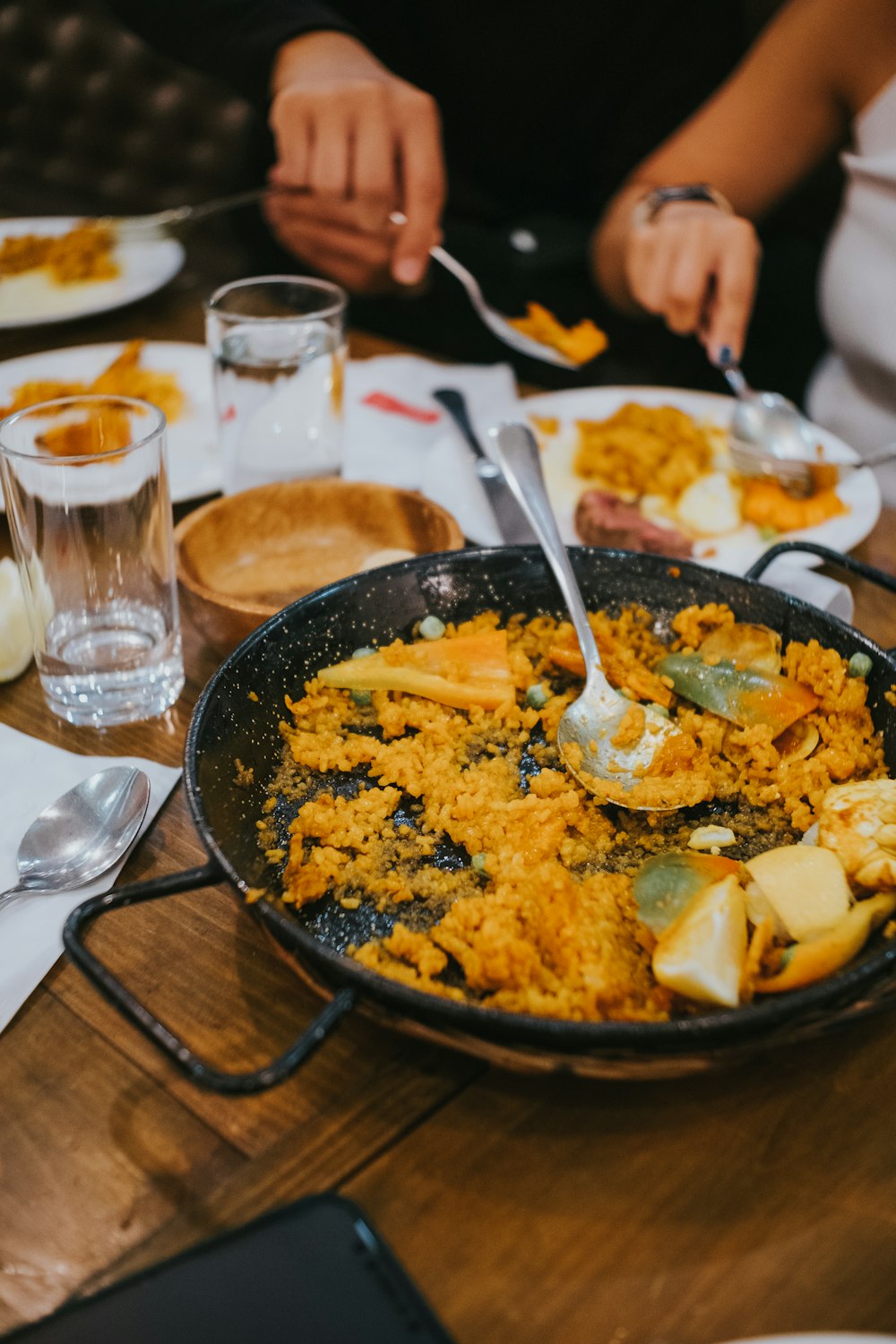 a pan filled with food sitting on top of a wooden table