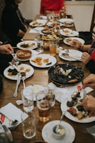 a group of people sitting around a table eating food