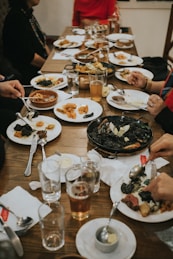 a group of people sitting around a table eating food
