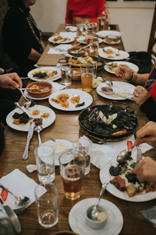 Cheerful staff serving a table with happy diners enjoying seafood dishes inside billyon.
