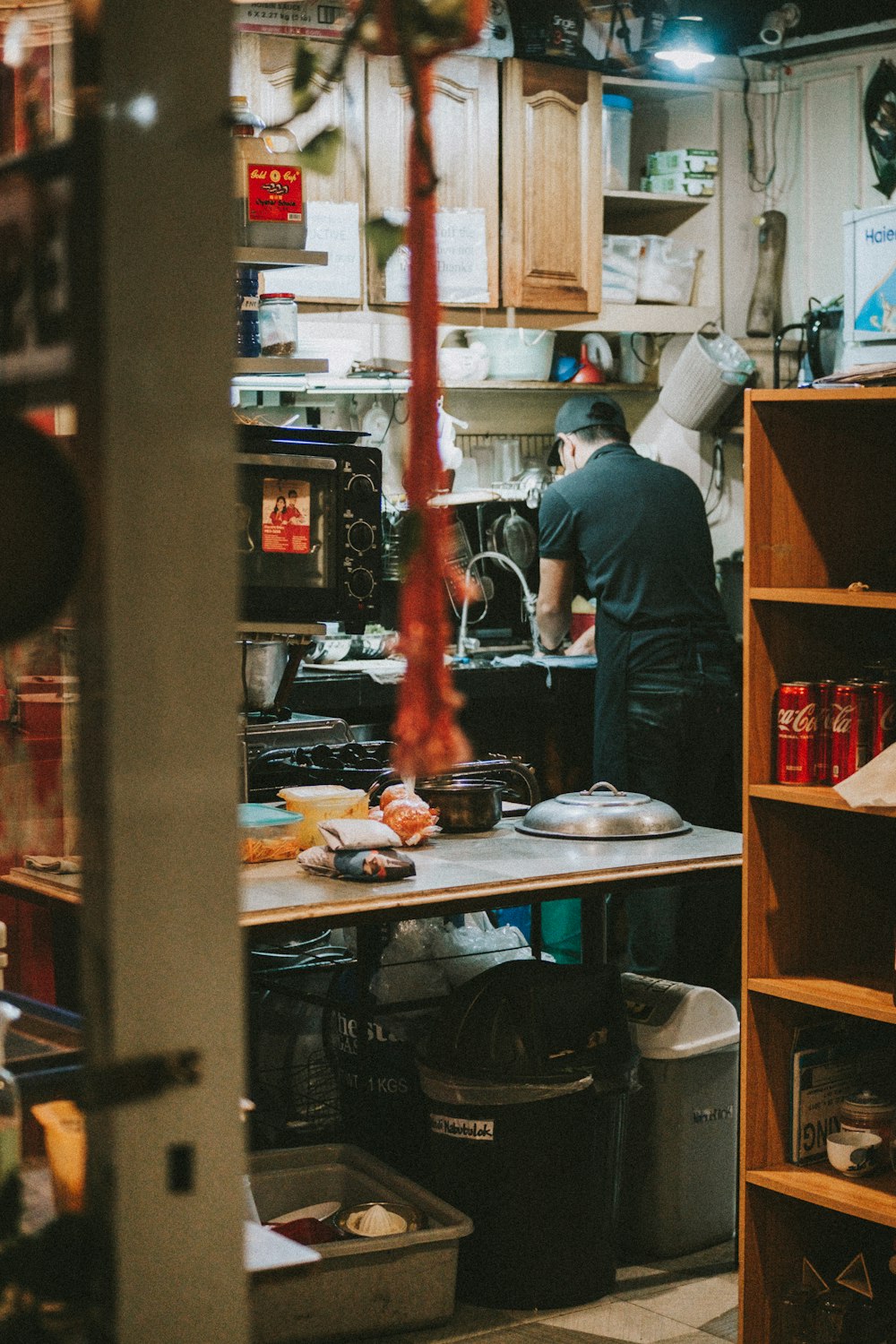 a man standing in a kitchen preparing food