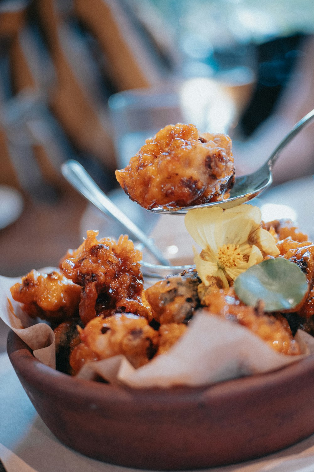 a wooden bowl filled with food on top of a table