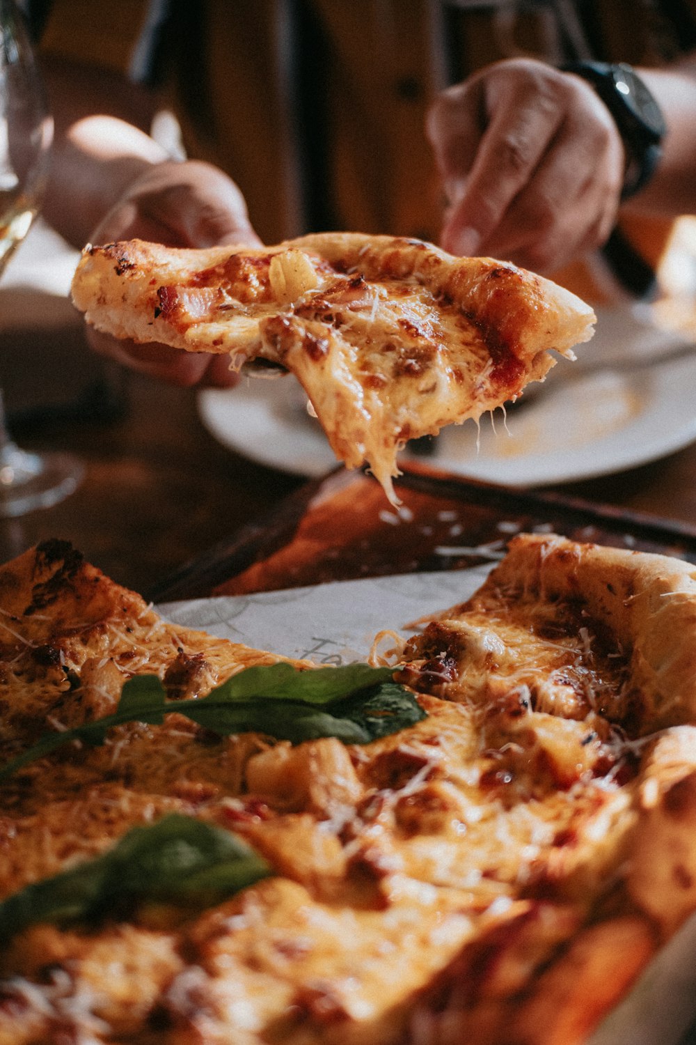 a close up of a person eating a slice of pizza