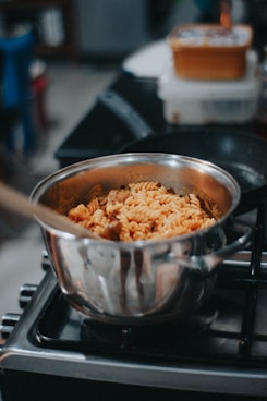 a pan filled with food sitting on top of a stove