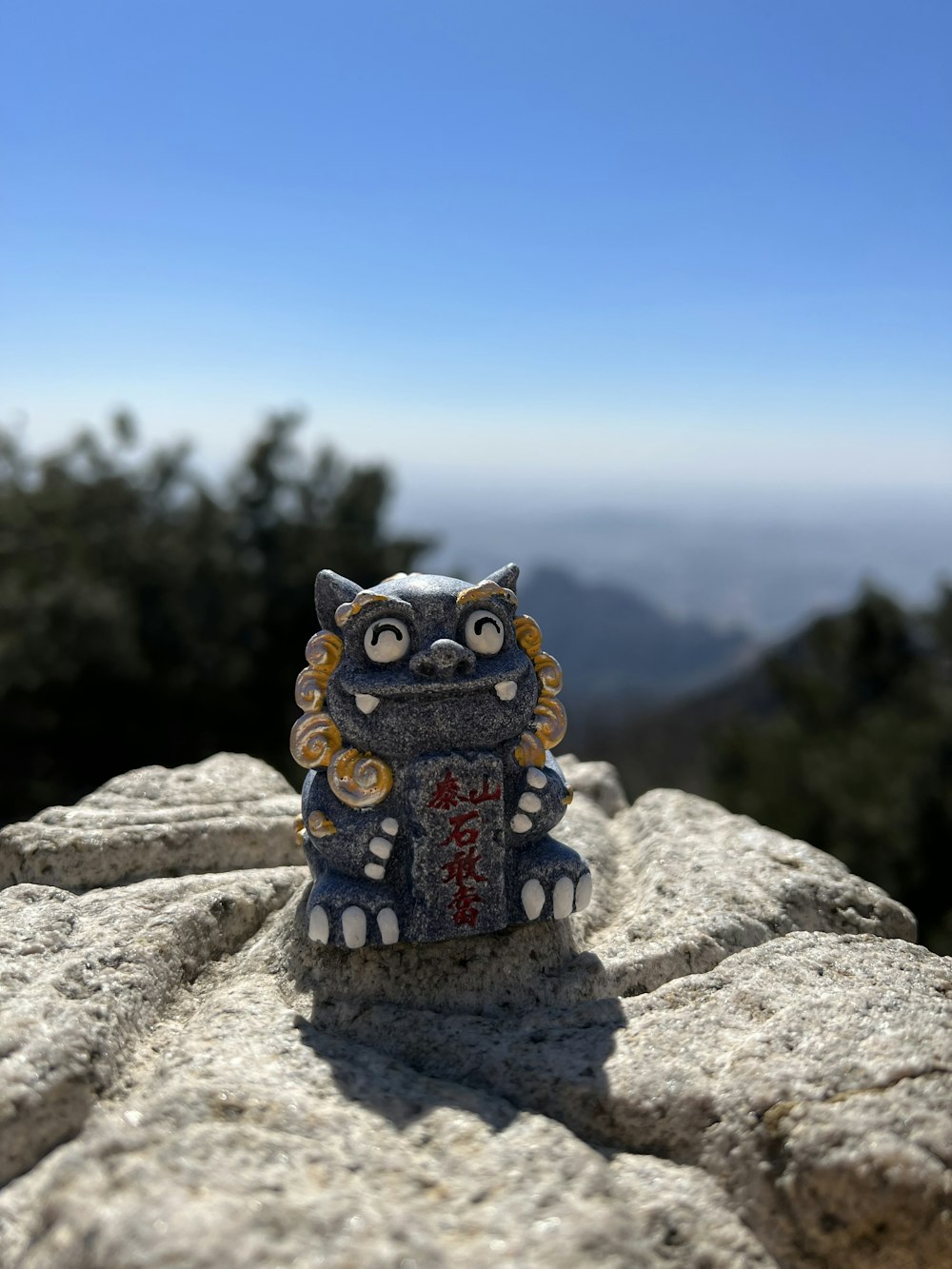 a statue of a cat on top of a rock