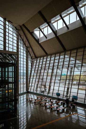 A warm, welcoming shelter lobby with digital screens showing real-time bed availability and AI dashboards in use.