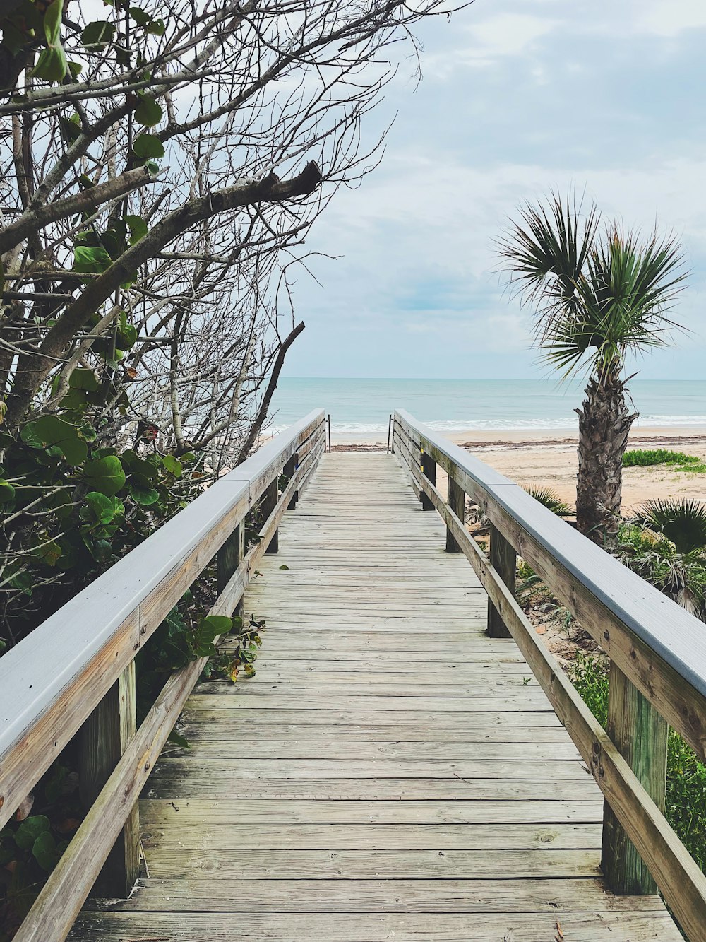 a wooden walkway leading to the beach