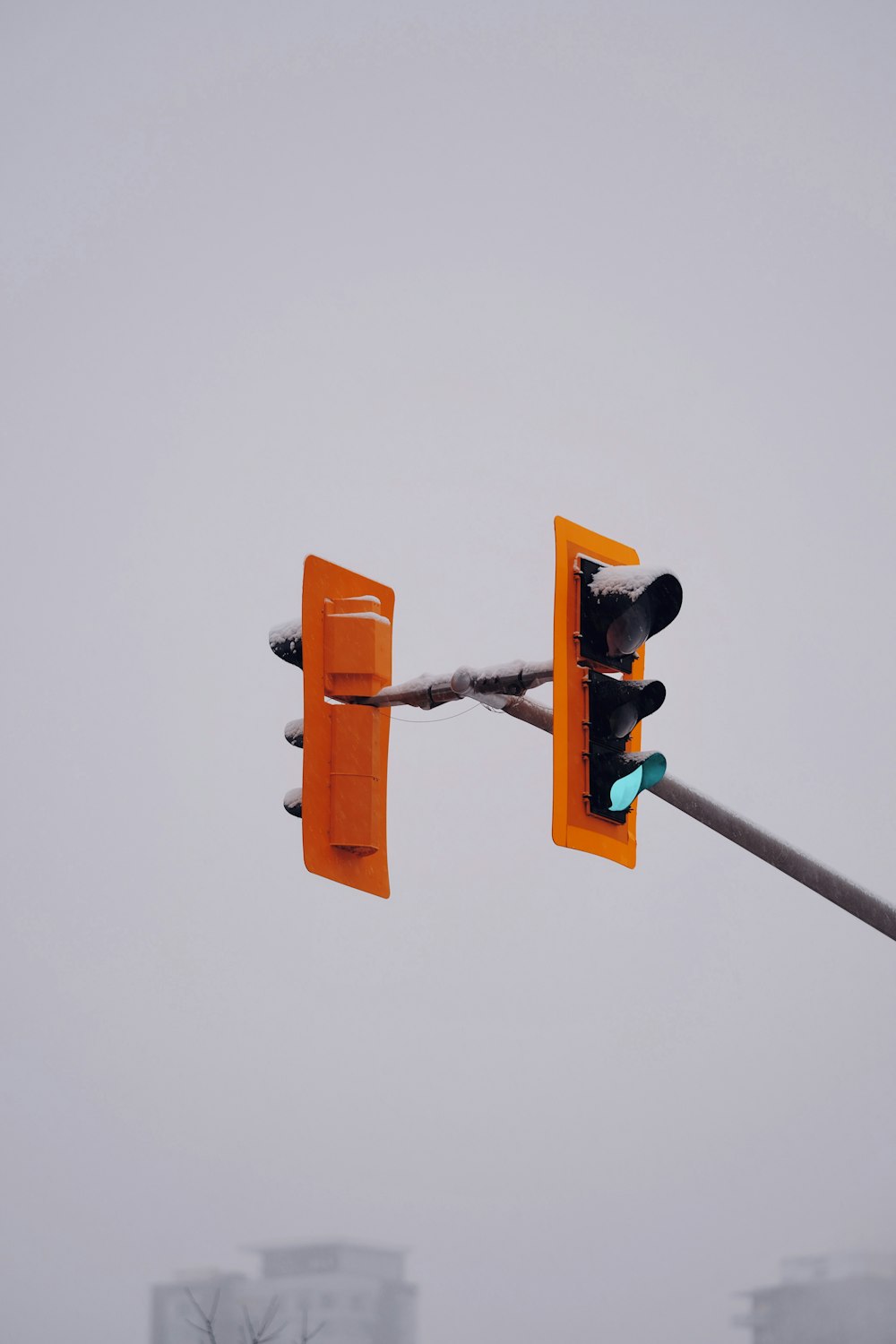 a traffic light hanging from the side of a pole