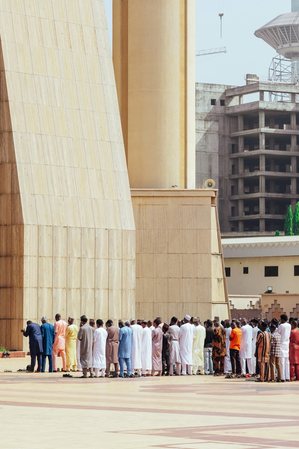 a group of people standing in a line in front of a building