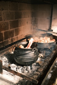 A slow-cooked stew bubbling gently in a cast iron pot over a rustic stove.