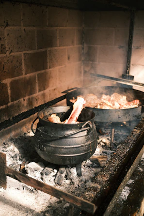A cozy kitchen scene featuring a cast iron Dutch oven simmering a hearty stew.