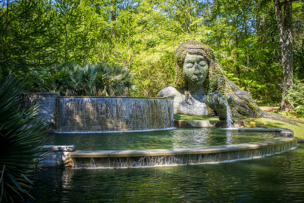 a water fountain with a statue in the middle of it