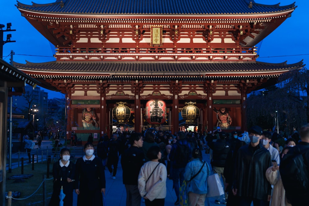 a group of people standing in front of a building