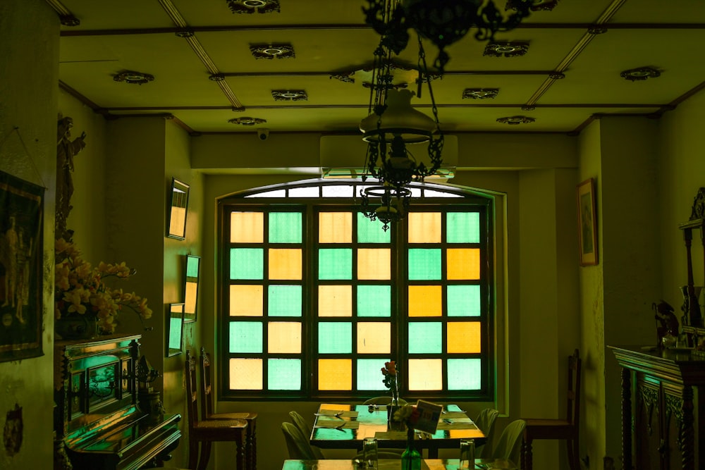 a room with a large window and a chandelier