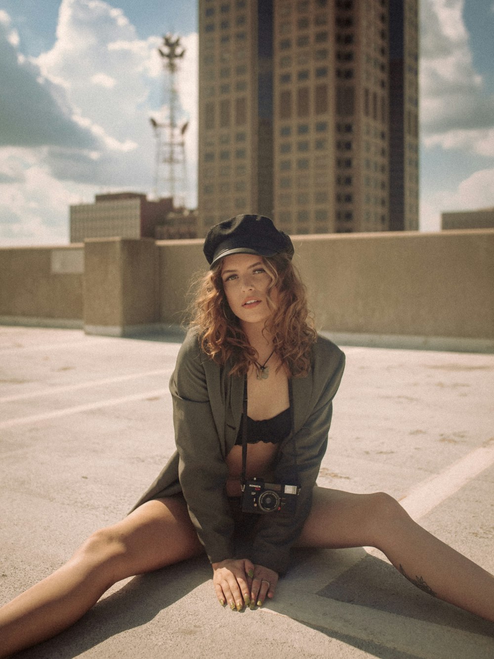 a woman sitting on the ground with her legs crossed