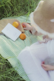 A playful scene of children enjoying a picnic with bowls of fresh berries and sliced oranges.