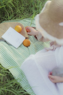 A playful scene of children enjoying a picnic with bowls of fresh berries and sliced oranges.