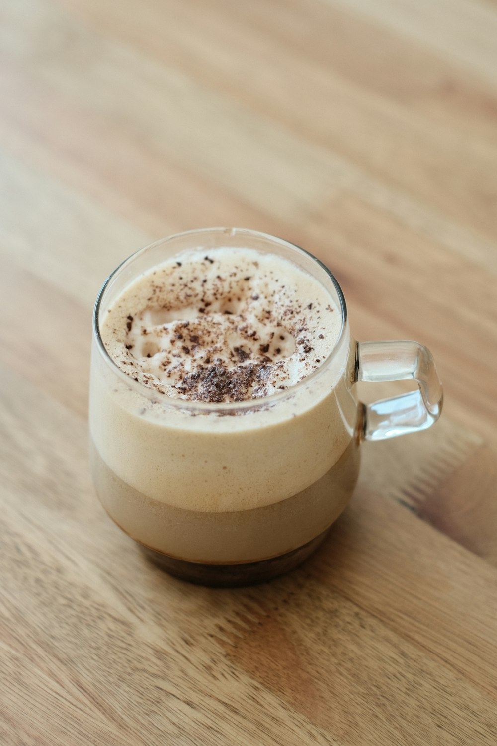 a close up of a drink on a wooden table